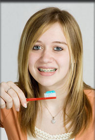 stock photo of a girl with braces with a toothbrush